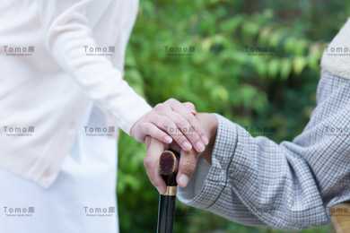 杖を持った男性患者と女性看護師の手元の画像